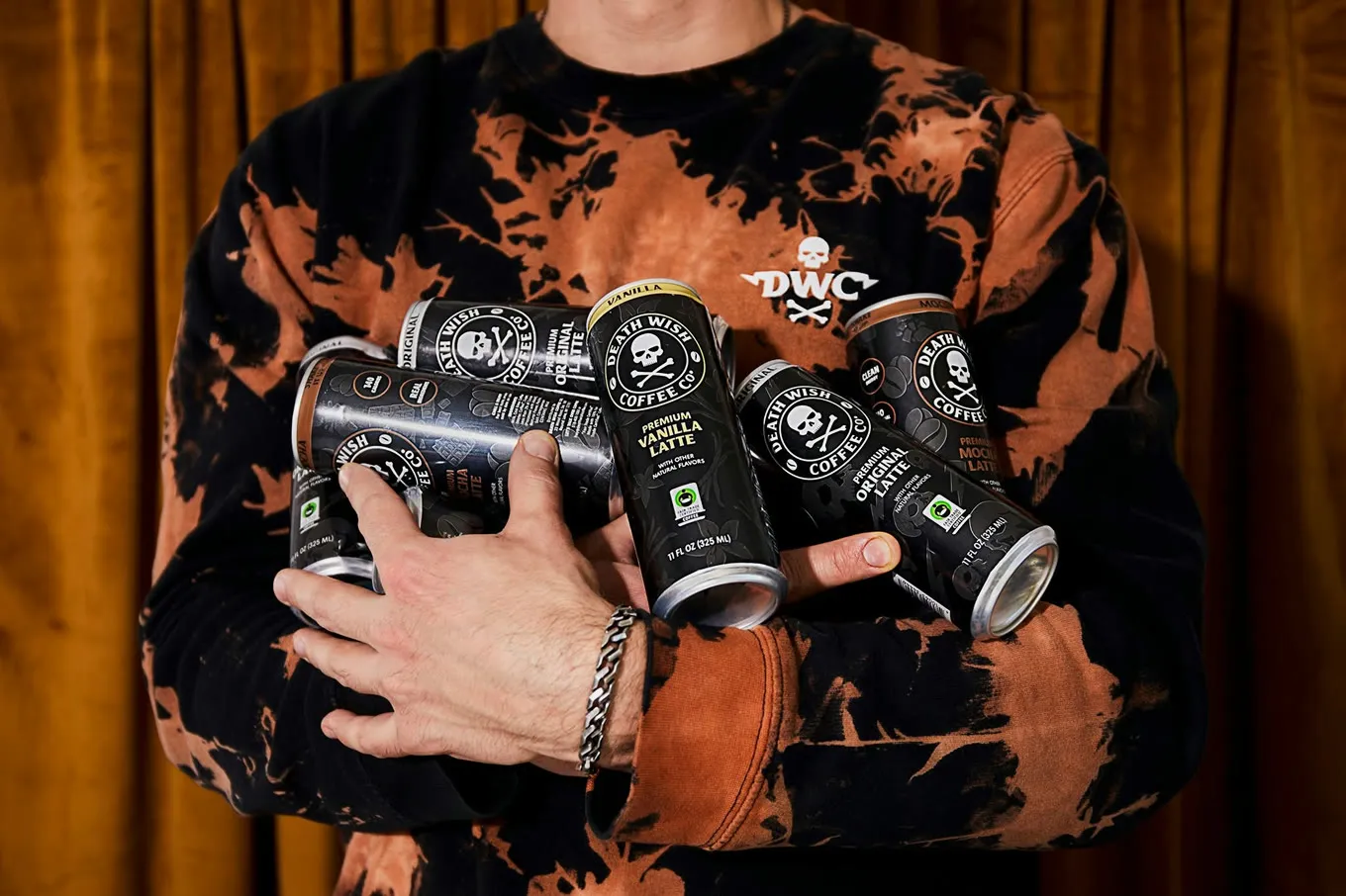 Death Wish Coffee canned lattes held in both arms