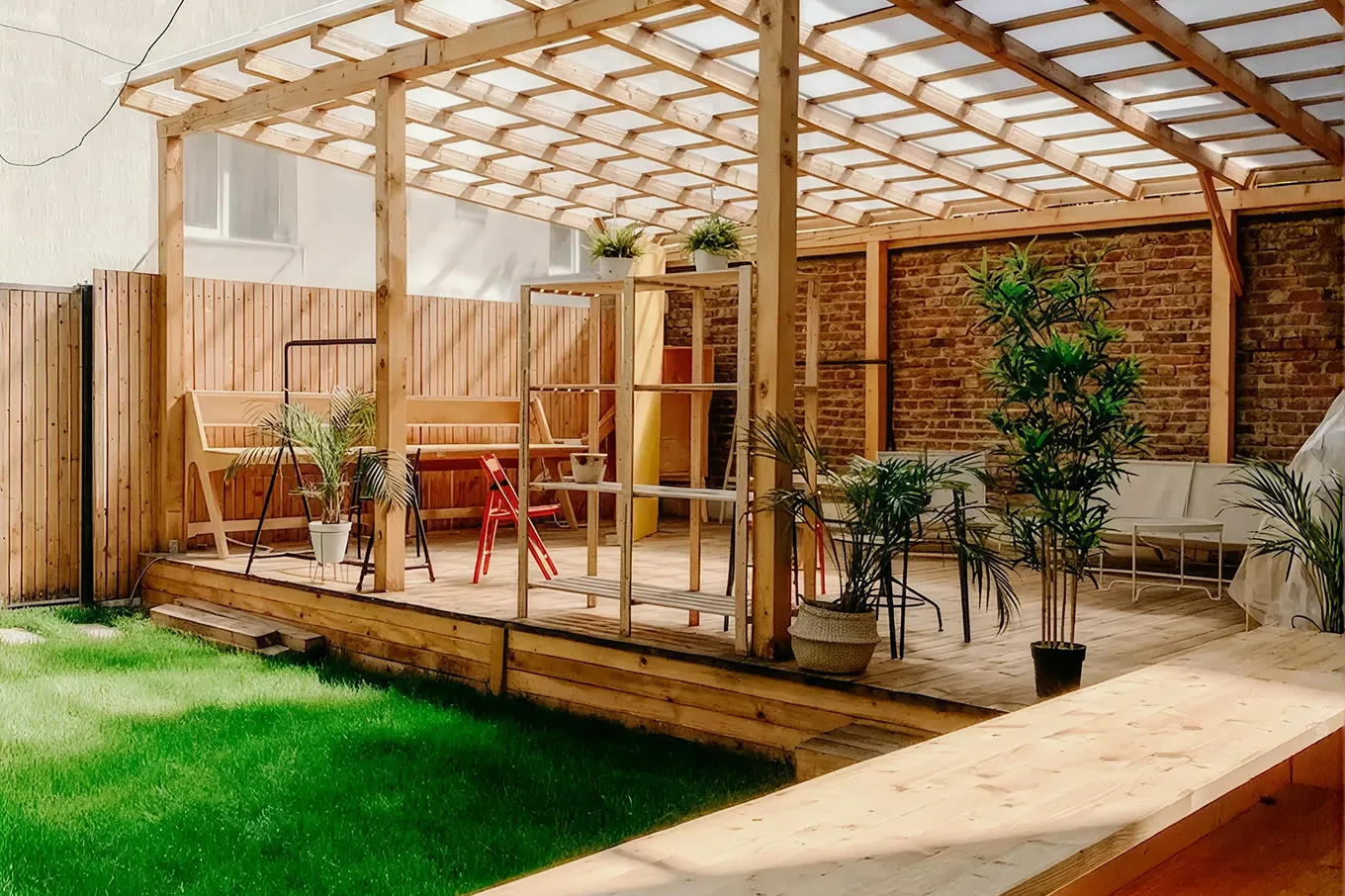 Timber pergola over a decked garden with planting