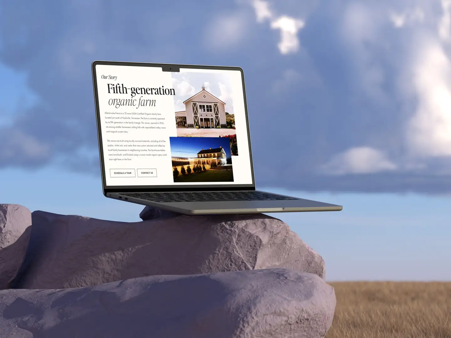 Laptop on a rock in open country, showing a fifth-generation organic farm site